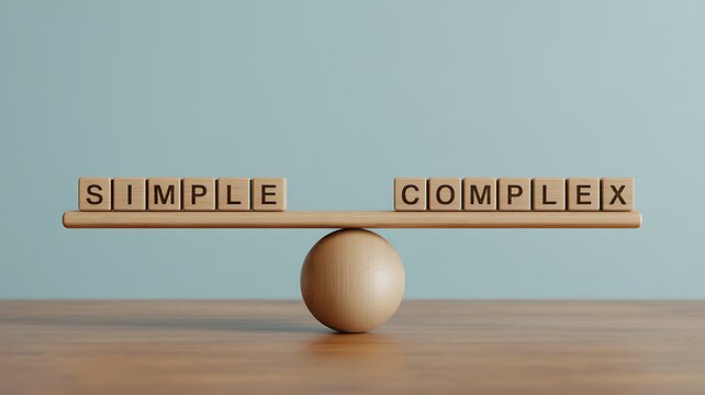 A wooden balance scale with blocks spelling simple and complex