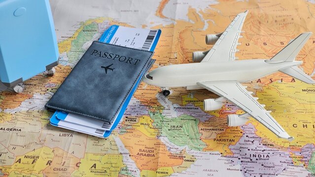 Travel preparations with a passport, airplane model, and map