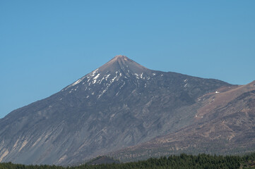 Fototapeta premium Mount Teide Snow Capped Peak With Pine Forest In Tenerife Canary Islands