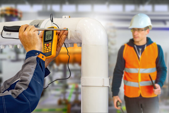 Gas leak detection, technician checks industrial pipeline for vapor substance leakage with detector while safety engineer supervises