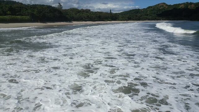 Aerial drone view of waves at tropical beach in Brazil