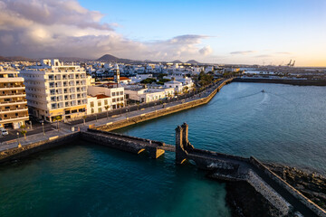 Naklejka premium Aerial drone view of the beauty of Arrecife town on Lanzarote island through breathtaking aerial views showcasing the coastline, local buildings, and scenic landscape