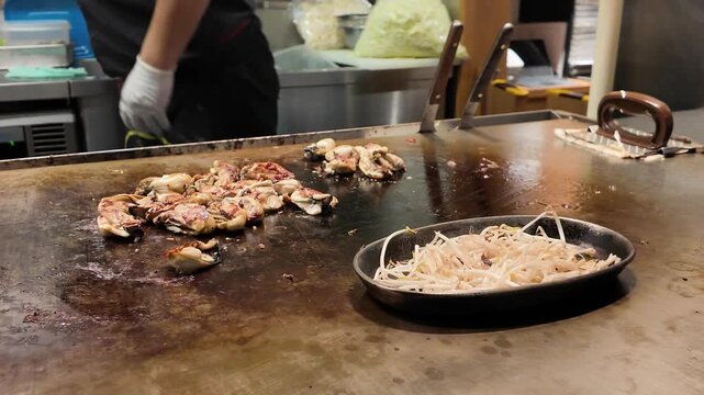 Beansprouts and Hiroshima Oysters Cooking on Hot Grill at Okonomiyaki Shop in Hiroshima Japan
