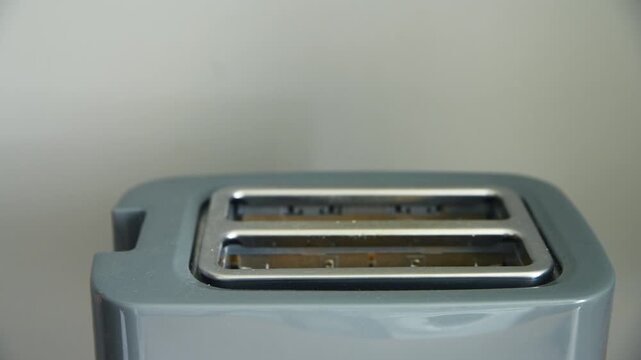 Close up stainless steel two slice toaster front view minimal kitchen background smooth lighting