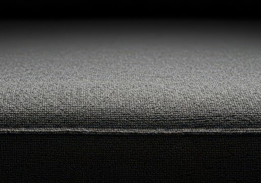 Detailed close up shot of a luxurious, soft grey sofa fabric texture. Neutral woven textile background or upholstery surface pattern, weave, backdrop, abstract