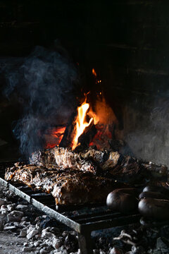 Flame Grilled Argentine Beef Ribs on Rustic Charcoal Barbecue.