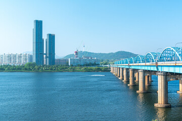 Fototapeta premium Seoul, South Korea - Mar. 01, 2026 : Scenic View of Dongjak Bridge over Han River with Namsan Seoul Tower under Clear Blue Sky in Spring 