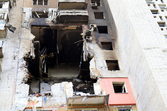 Russian missile strike destroyed house in Dnipro, Ukraine. A large hole in residential building after drone strike and a fire. Russia s war against Ukraine.
