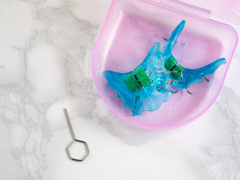 Blue double orthodontic block with pink storage case. Bite correction and pediatric orthodontics.