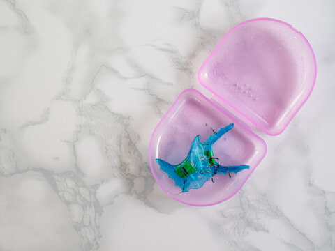 Blue double orthodontic block with pink storage case. Bite correction and pediatric orthodontics.