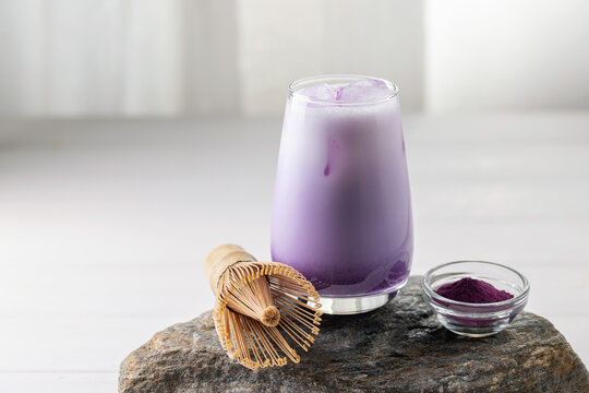 Ube latte in glass. Healthy vegan drink. Viral trendy asian beverage