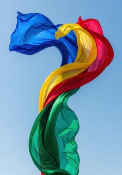 A vibrant, lightweight textile billows dramatically against a bright blue sky, caught in a powerful, refreshing summer updraft, breeze, vitality, summer