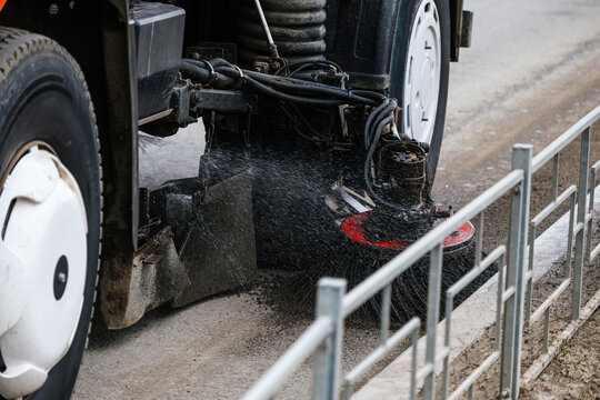 Vehicle sweeping streets, cleaning up sidewalk