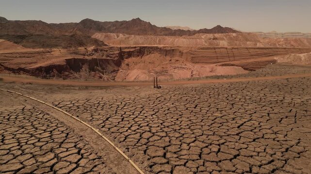 Aerial View of Cracked Desert Ground and Red Cliffs in Timna Israel