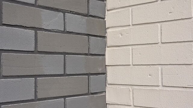 Sunlight casting a moving shadow over a gray and white brick wall corner revealing its texture and details video Full HD