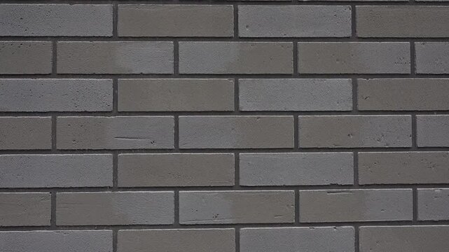 Textured grey brick wall slowly moving creating an abstract background for construction and architecture concept video Full HD