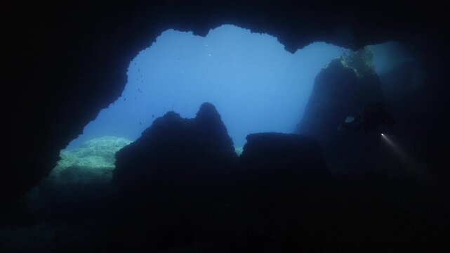 cave diving underwater scuba divers exploring caves and having fun ocean scenery sun beams and rays background