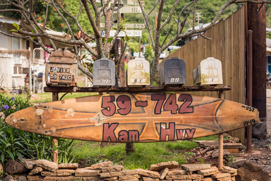 Vintage surfboard house sign and mailboxes on Kamehameha Highway in Oahu, Hawaii