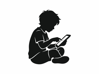 Silhouette of a little boy sitting and playing with a digital tablet or smartphone