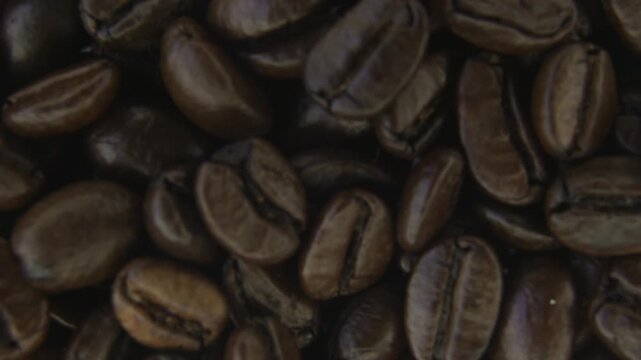 Rotating Coffee Beans With Atmospheric Smoke Macro.