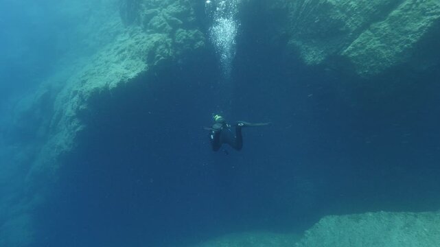 scuba divers exploring caves underwater cave diving