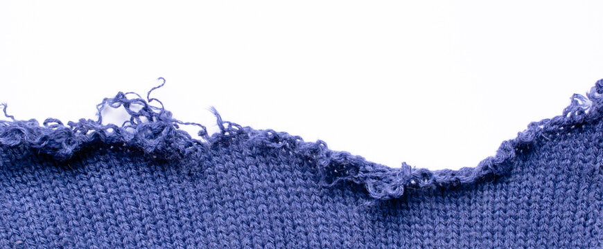 a piece of a torn blue woolen sweater