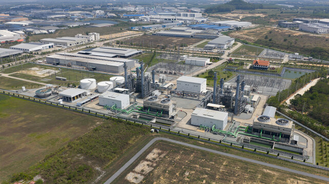Aerial view of the Amata B.Grimm Power Rayong 3 Ltd. industrial complex featuring cooling towers and electrical infrastructure Tambon Mapyangphon, Chang Wat Rayong, Thailand.