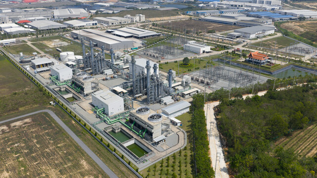 Aerial view of the Amata B.Grimm Power Rayong 3 Ltd. industrial complex featuring cooling towers and electrical substations in Tambon Mapyangphon, Chang Wat Rayong, Thailand.