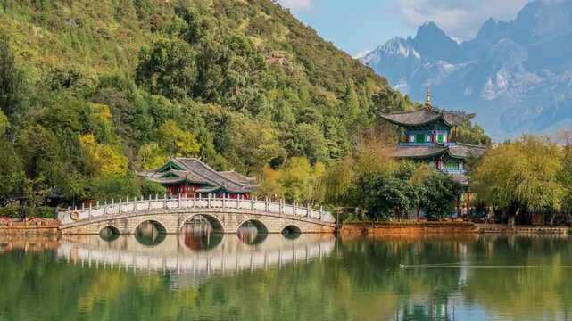 Black dragon pool park scenic view featuring traditional chinese architecture ornate marble bridge jade dragon snow mountain background lijiang yunnan china.