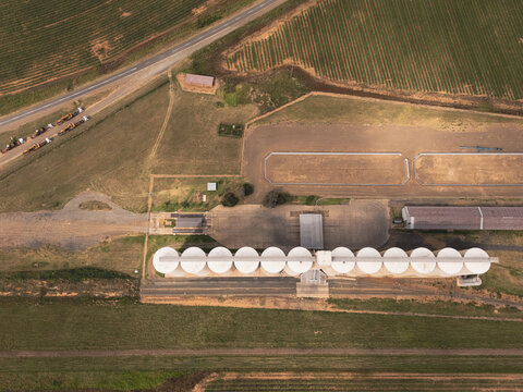 Aerial view of a large grain silo facility with white storage bins surrounded by agricultural fields in Thabo Mofutsanyana District Municipality, Free State, South Africa.