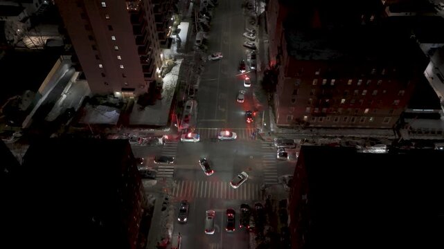 Aerial night view of police cars at a city intersection