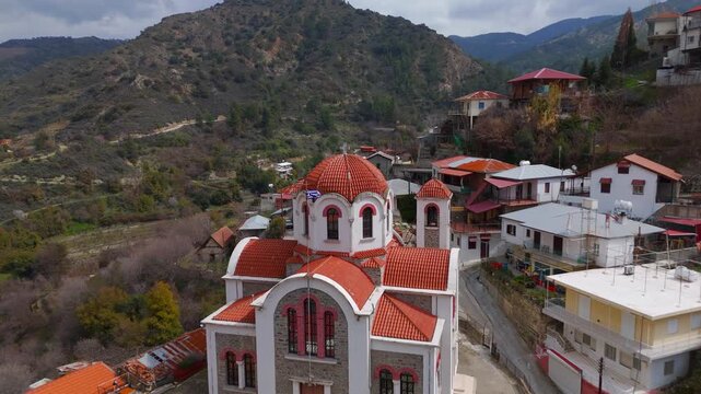 Aerial Flyover of Agia Paraskeui Church and Forested Moutoullas Village Valley in Cyprus
