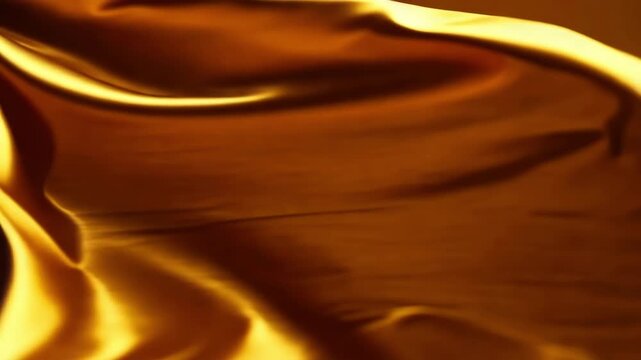 Golden flowing silk fabric background with gold waves and soft texture Premium gold abstract background video