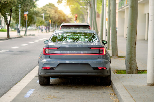 Rear View of Modern Gray Electric Car Parked On The Street