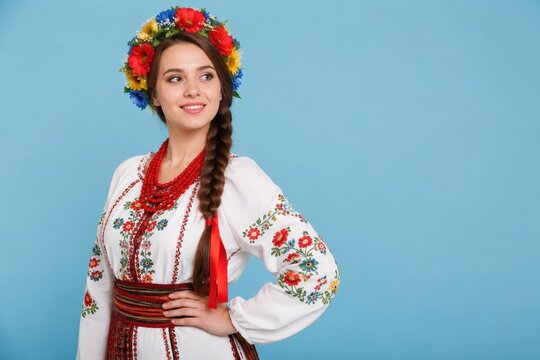 Young woman in traditional Ukrainian embroidered shirt wearing flower wreath. National folk costume with red beads. Cultural heritage, patriotic pride, ethnic celebration, Slavic beauty, copy space