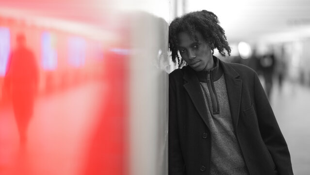 Moody African Man in Black and White with Red Blurred Foreground and Copy Space