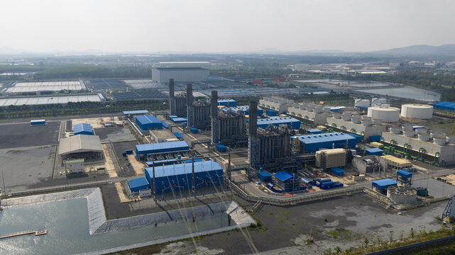 Aerial view of the Gulf Pluak Daeng GPD power plant industrial complex with cooling towers and storage tanks in Map Yang Phon, Rayong, Thailand.