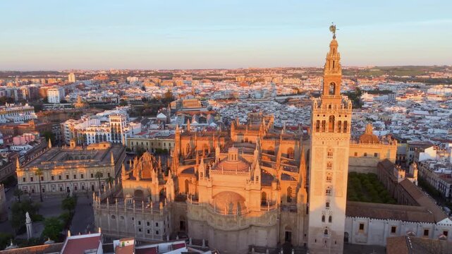 Aerial glimpse of Seville at sunset. Golden hour illuminates historic Seville city and architecture