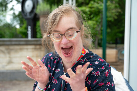 Excited woman with Down syndrome celebrating outdoors