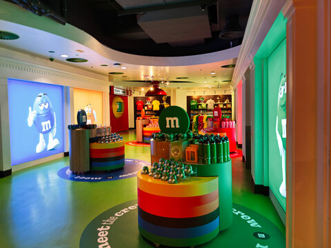 Colorful Mand M's store interior in London, UK with candy displays, branded merchandise, interactive exhibits and vibrant retail design