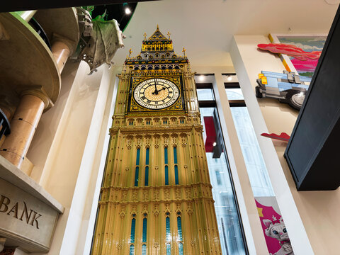 Detailed Big Ben clock tower replica display inside a LEGO store in London, UK with ornate golden architecture and towering interior perspective