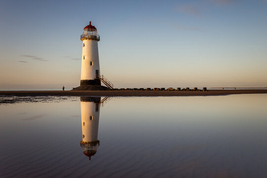 Perfect reflection of Point of Ayr Lighthouse in still tide pool water