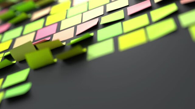 Colorful sticker notes on black wall display green yellow pink and peach tones against a dark charcoal surface. The scattered arrangement suggests active planning or task organization. Ideal for