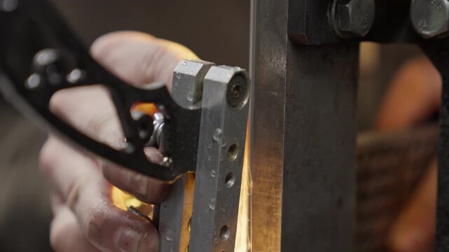 Knife is sharpened by blacksmith in workshop during making