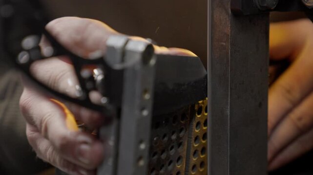 Knife is sharpened by blacksmith in workshop during making