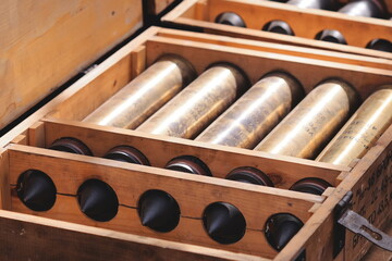 Naklejka premium A wooden box filled with numerous wine bottles