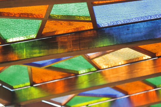 A detailed view of a stained glass bench with intricate designs and colors