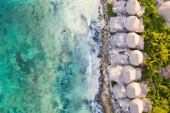 Aerial view of bungalow resorts on the Tulum coast in Mexico.