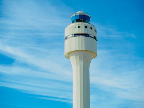 The image shows the Modern Air Traffic Control Tower  of the CLT(Charlotte Douglas International) airport Against Clear Blue Sky with Wispy Clouds.  Charlotte, NC USA. February 14th 2025.