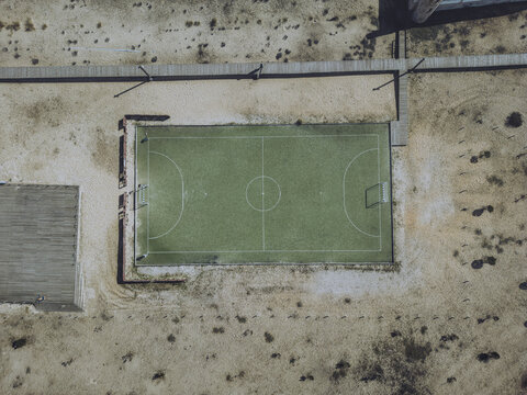 Aerial view of beach football pitch surrounded by sand and green field, Figueira da Foz, Coimbra, Portugal.